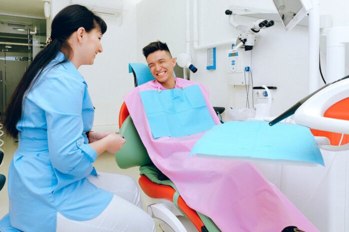 Dentist and a patient sitting in a chair