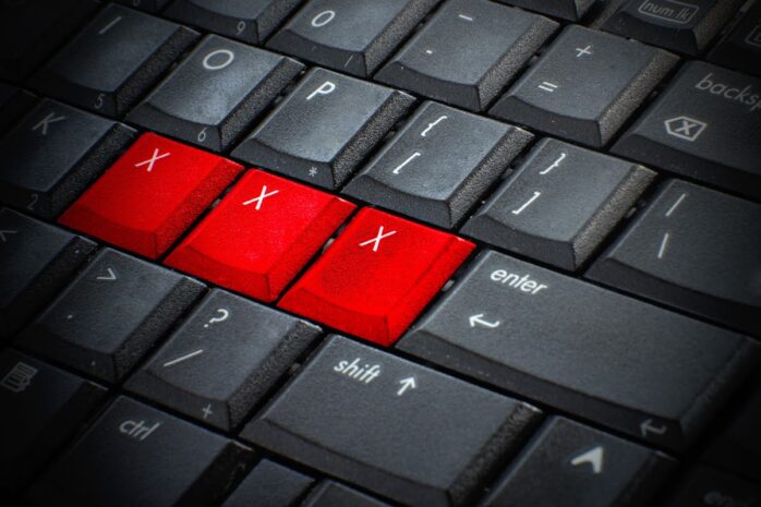 Red button Keywords xxx on keyboard computer, Adult sex online concept