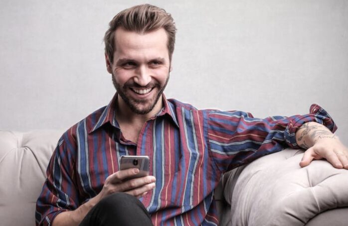 person looking at phone for Online Casino